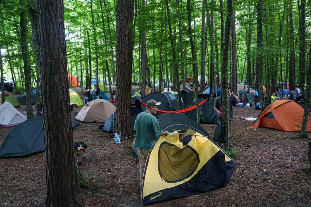 A man installs a tent during the Stoned Climbers festival...