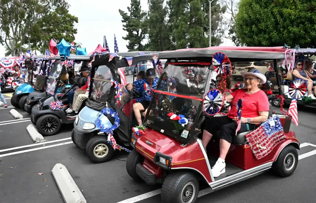 Decorated golf carts park along Clubhouse 2 as they gather...