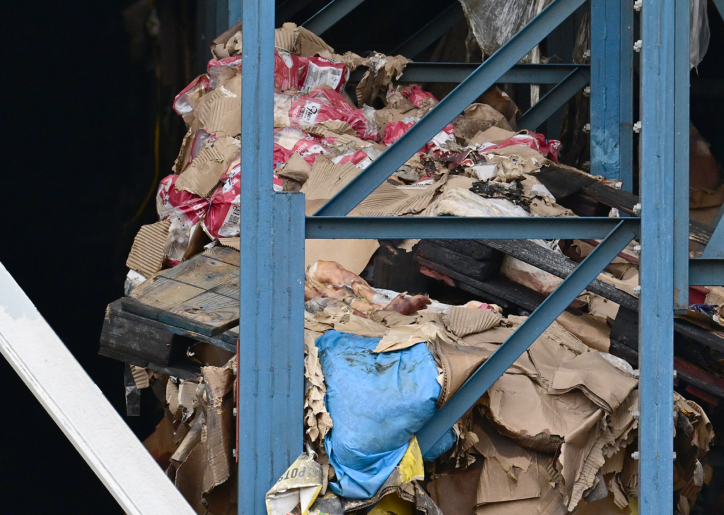 Burned contents in the warehouse. Residents and community organizations held...
