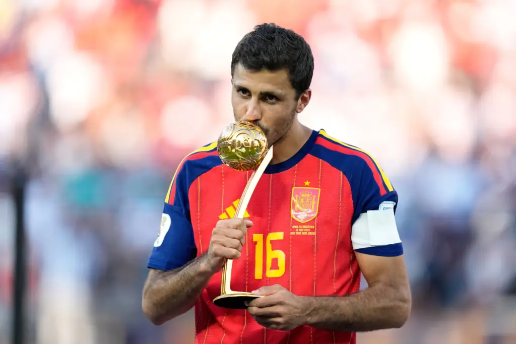 Spain’s Rodri poses with the tournament’s best player award at...
