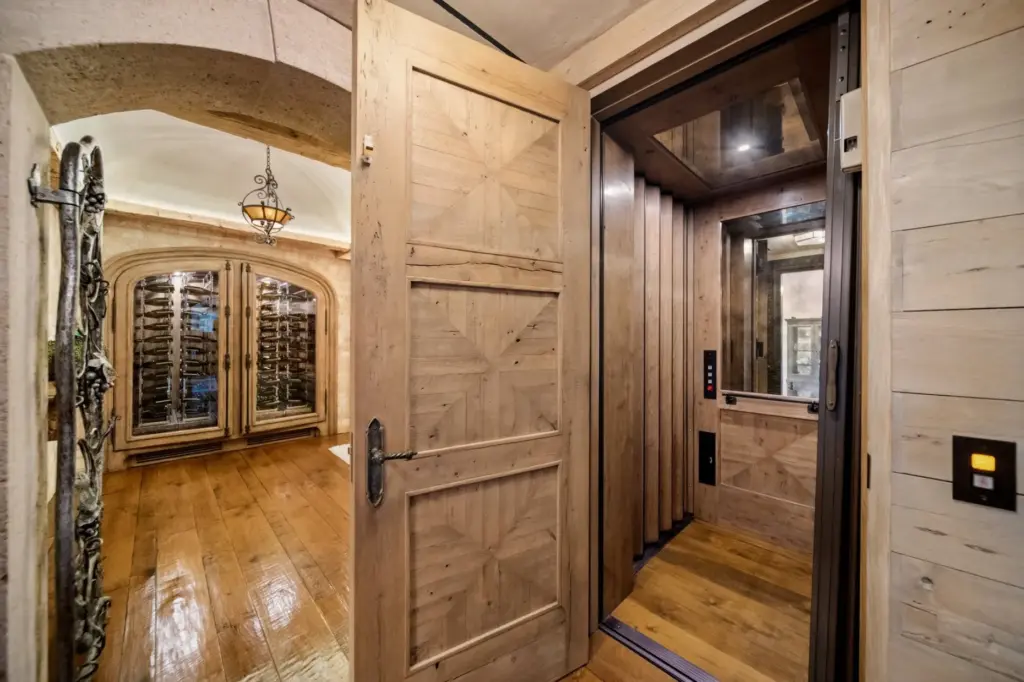The elevator opens to the lower level of the luxury...