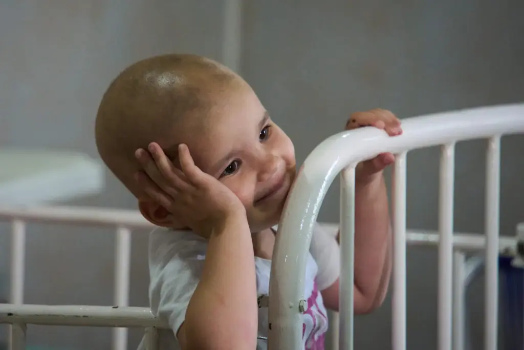 Nashly Zerquera, a 4-year-old oncology patient, sits in her bed...