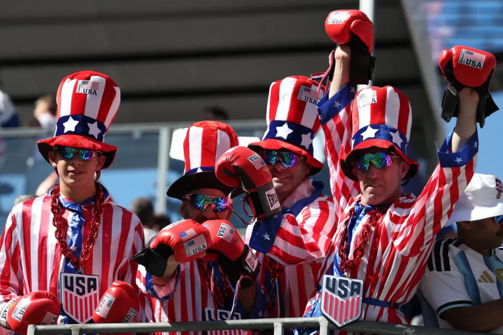 Fans react before the World Cup round of 16 soccer...