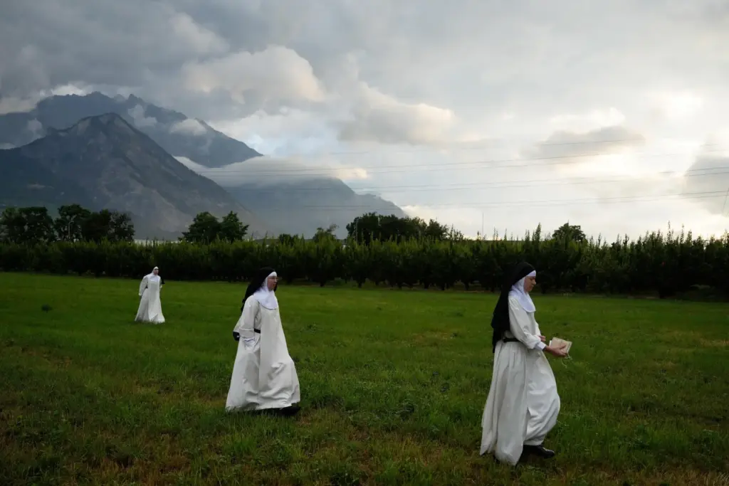 Nuns make their way to a tent set up outside the Society of St. Pius X seminary.