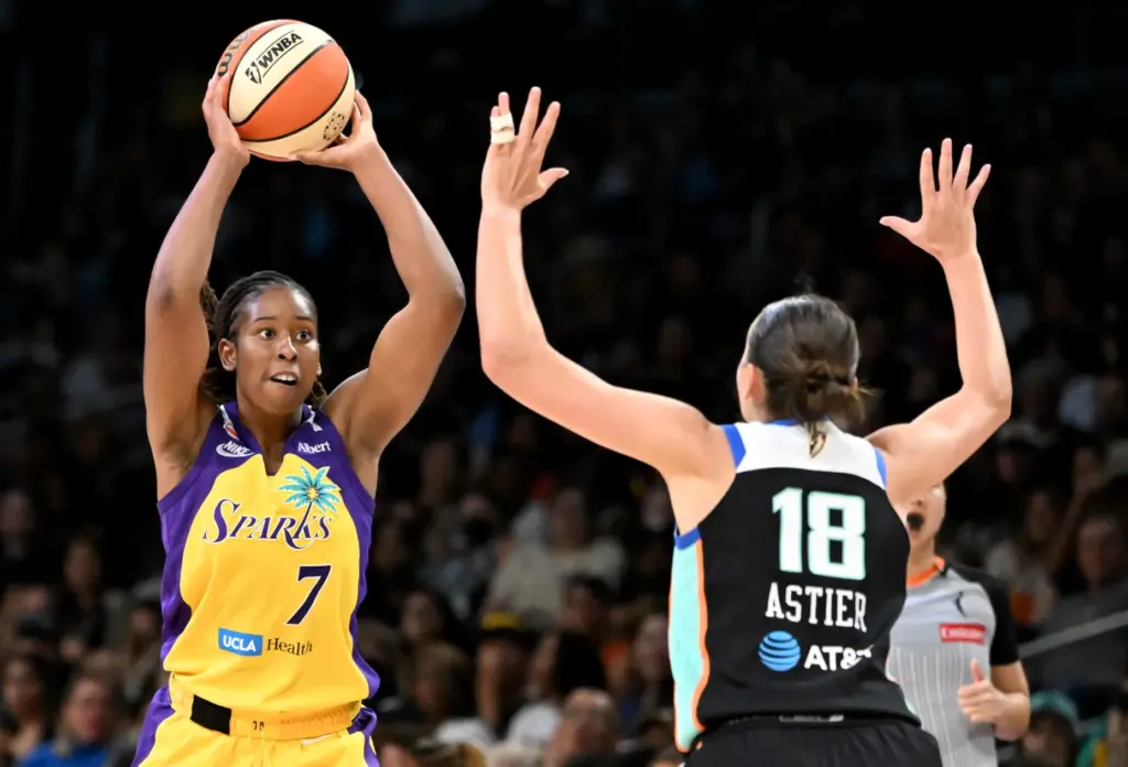 Sparks guard Ariel Atkins looks to pass the ball as...