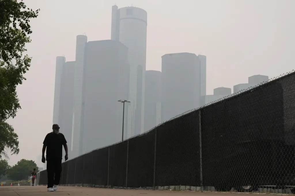 Jimmy Tyner walks along the Detroit River during poor air quality due to smoke.