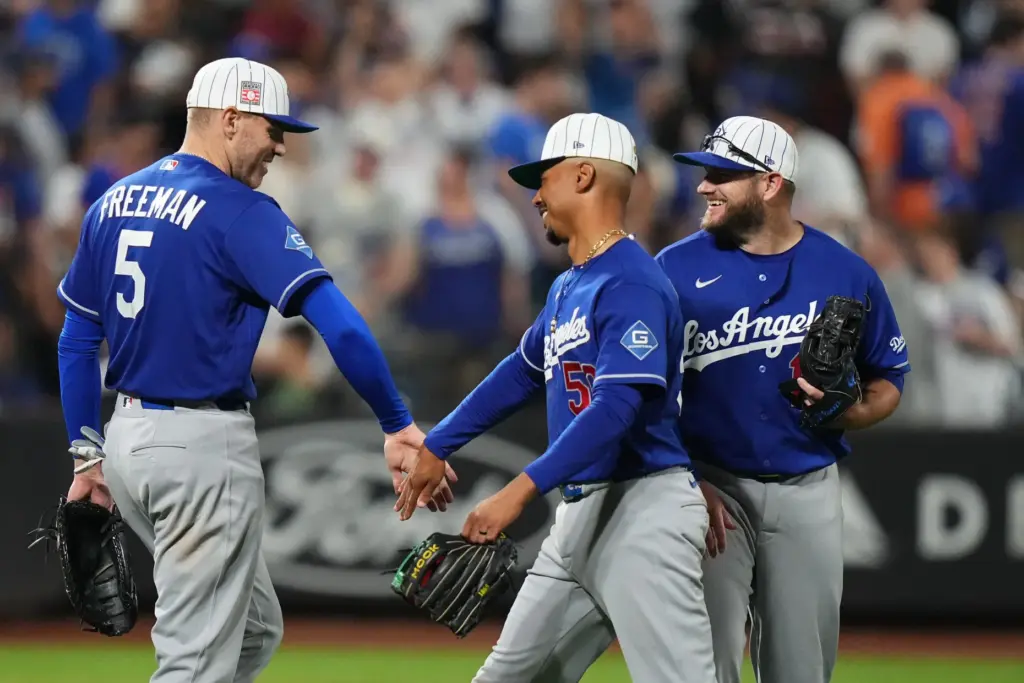 Los Angeles Dodgers’ Freddie Freeman (5) celebrates with teammates Mookie...