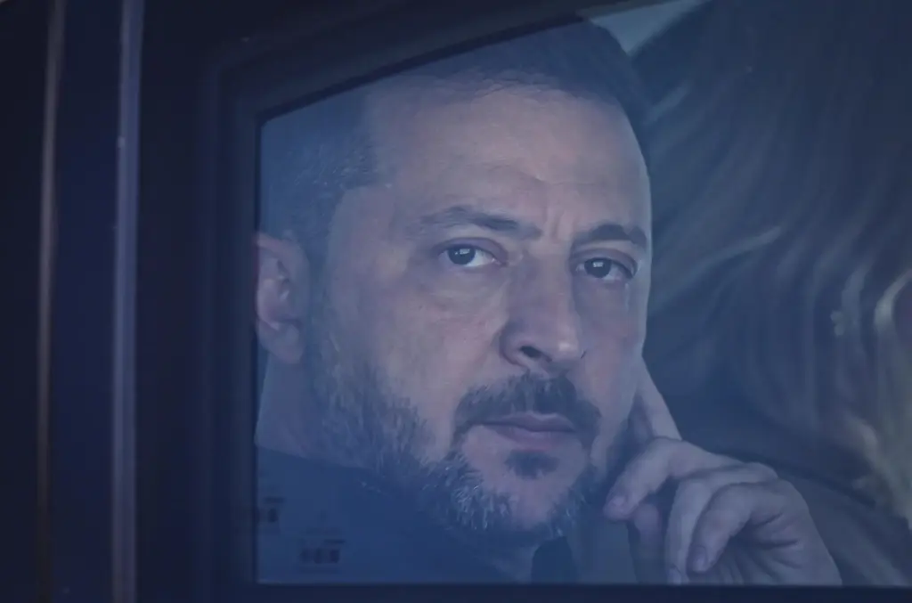 Ukraine's President Volodymyr Zelenskyy looks out from his car window.