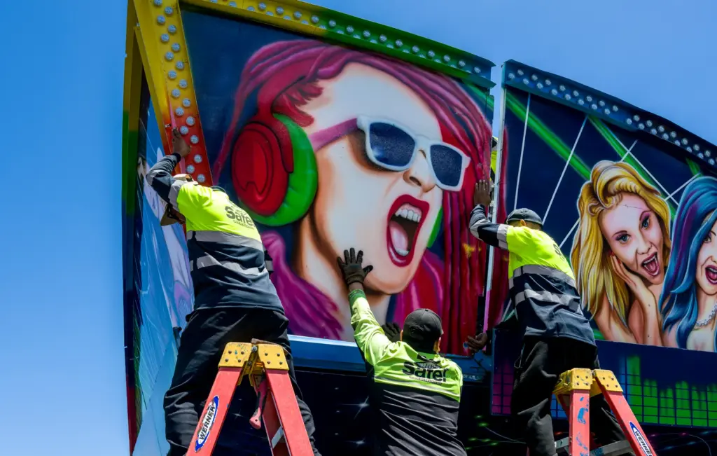 Crews assemble the sections of the Wave Rave ride at...