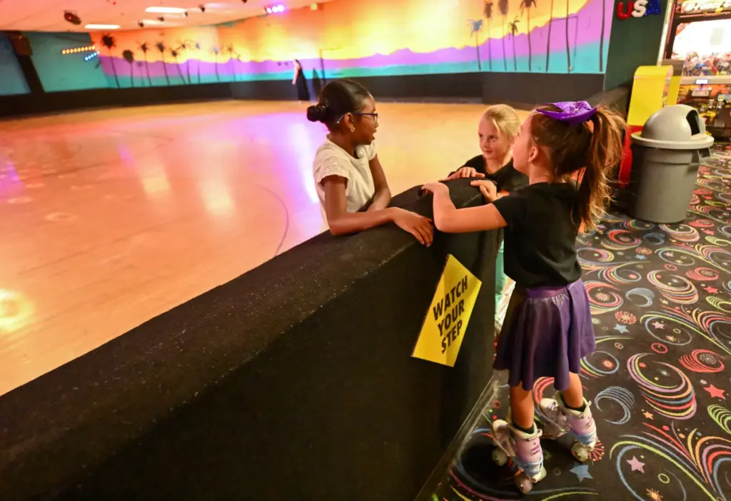 Josephine Hall, left, Scarlett Allan, center, and Bella Gomez chat...