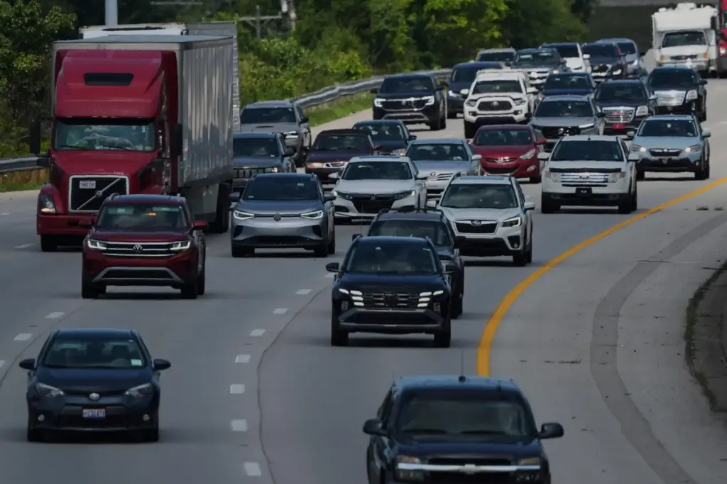 FILE – Vehicles drive along a highway July 30, 2025,...