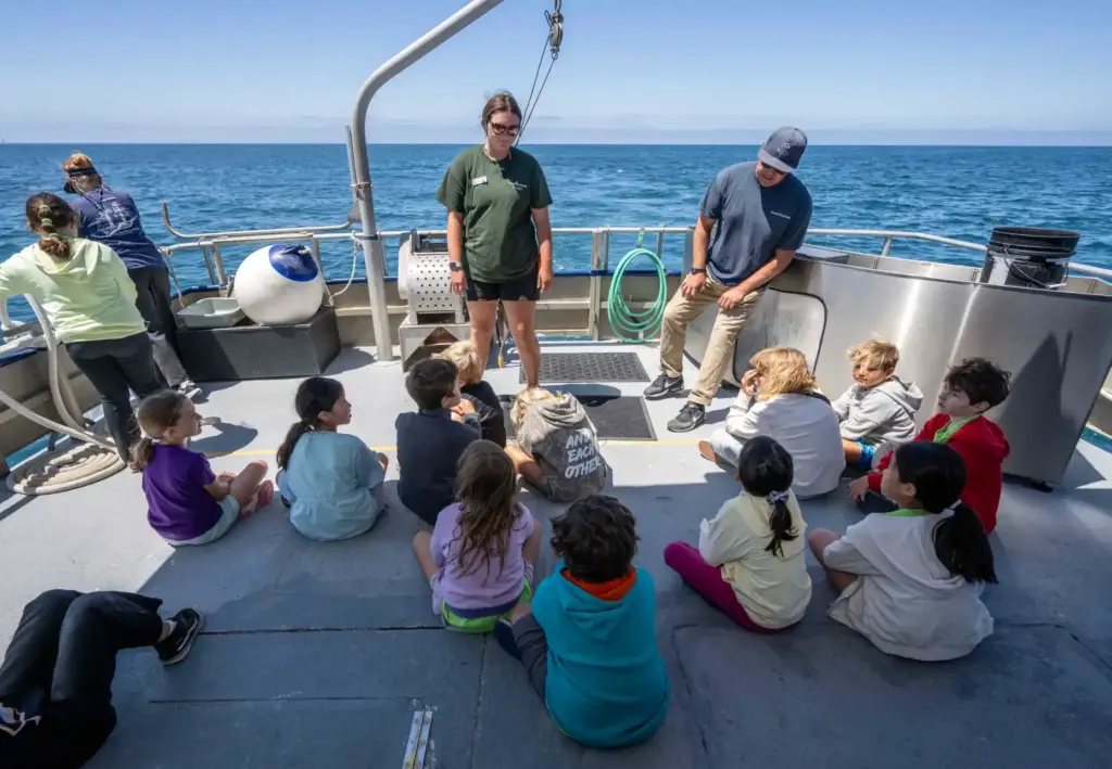 Cailin Holt, center, a Deck Hand aboard the Research Vessel...
