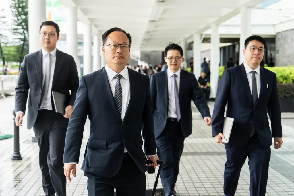 Jenkin Suen, second from left, lawyer for the government, leaves...