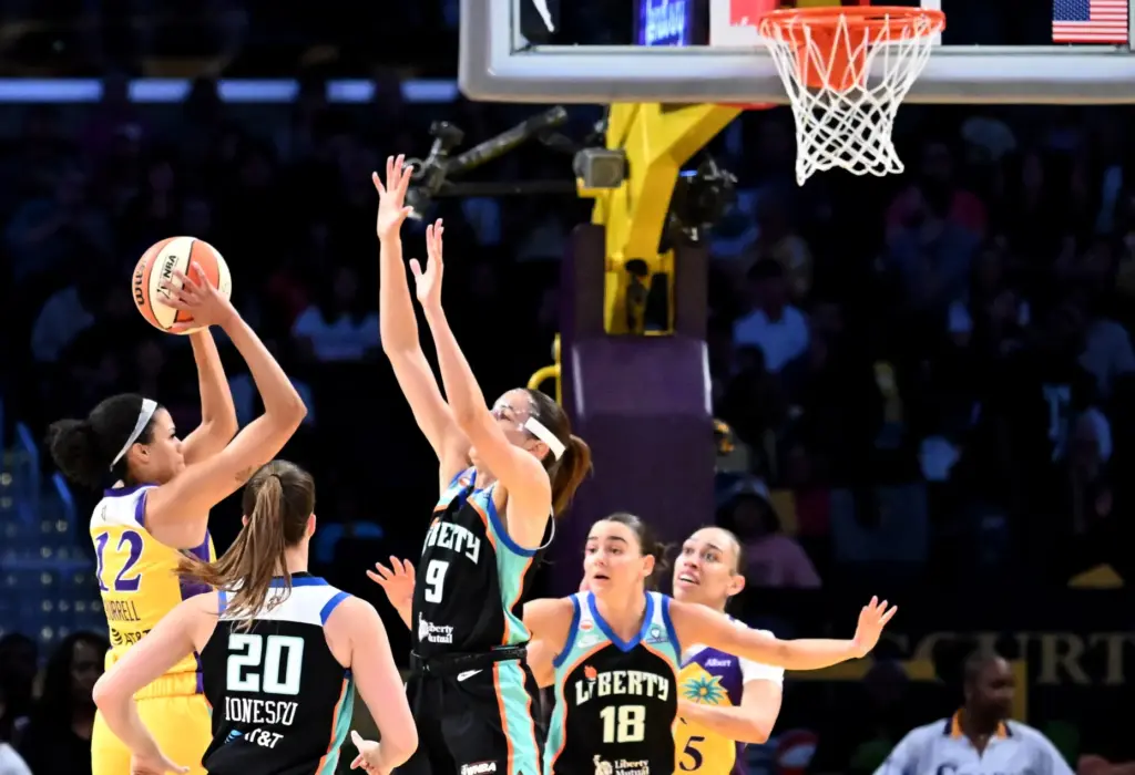 Sparks guard/forward Rae Burrell, left, looks to shoot as New...
