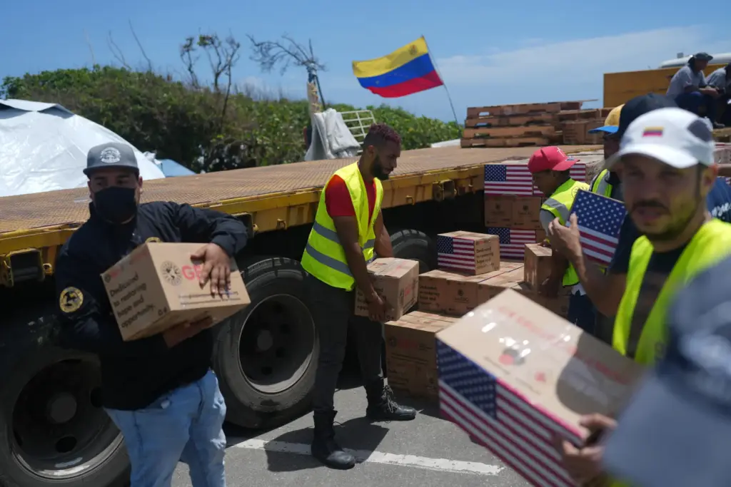 Relief workers unload U.S. humanitarian aid for people affected by the Venezuela earthquakes.