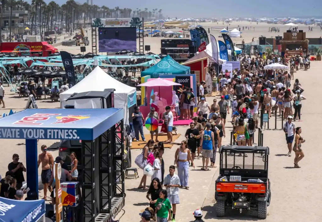 Hundreds of surf fans hang out in the temporary village,...