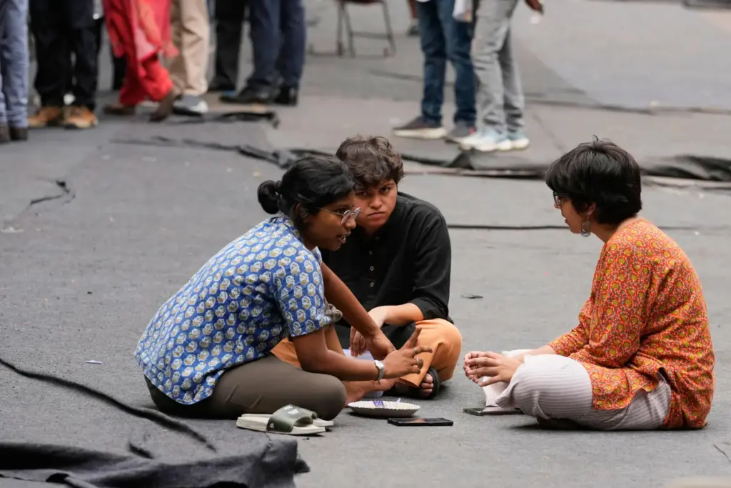 Volunteers of the Cockroach Janta Party sit and talk during a protest.
