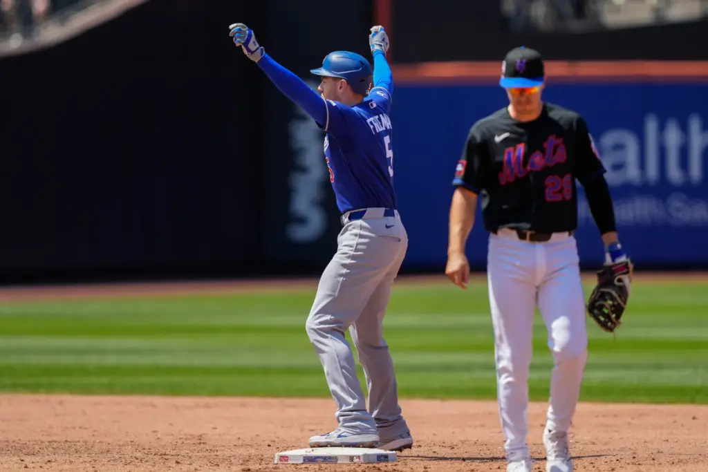 The Dodgers’ Freddie Freeman, left, reacts after hitting an RBI...