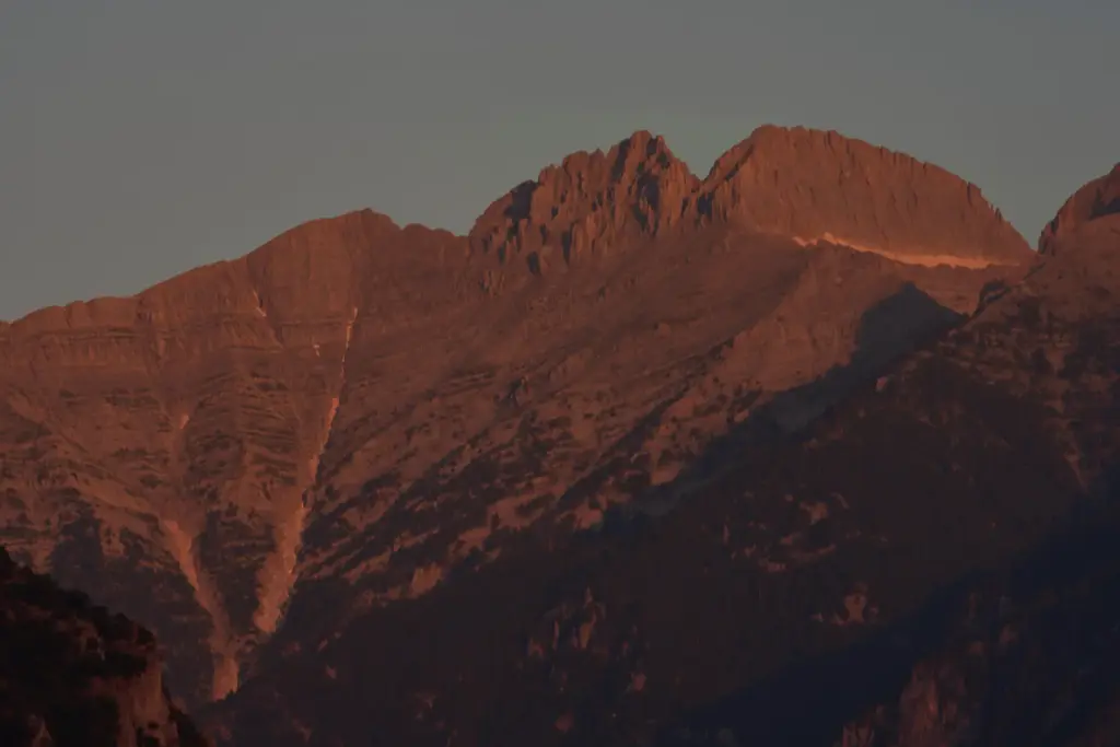 The morning light shines on Mytikas, Greece’s highest peak, center...