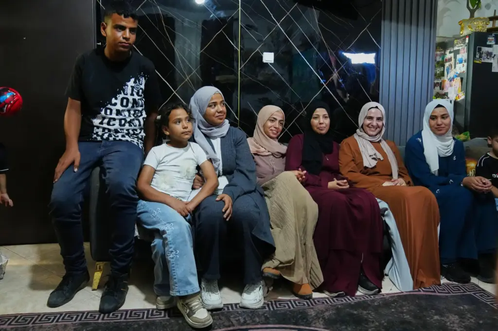Mais Al-Gharam, second from right, poses for a photo with...