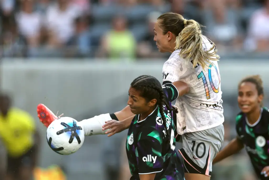 Angel City FC forward Claire Emslie (10) challenges Racing Louisville...