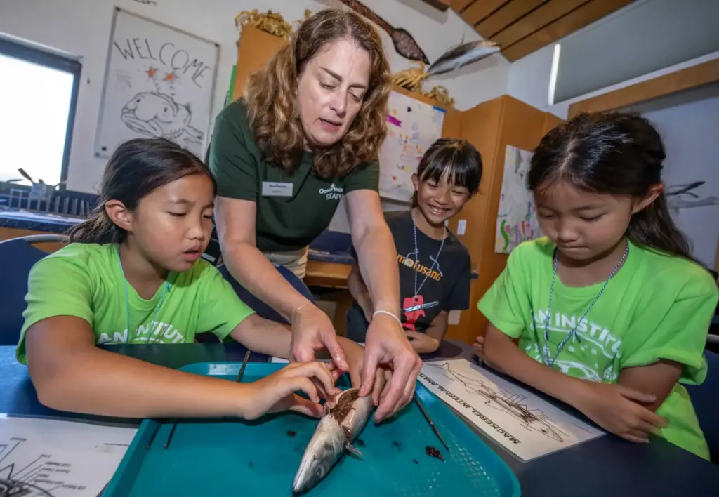 Megan Morrow, an Ocean Institute summer camp instructor, helps a...