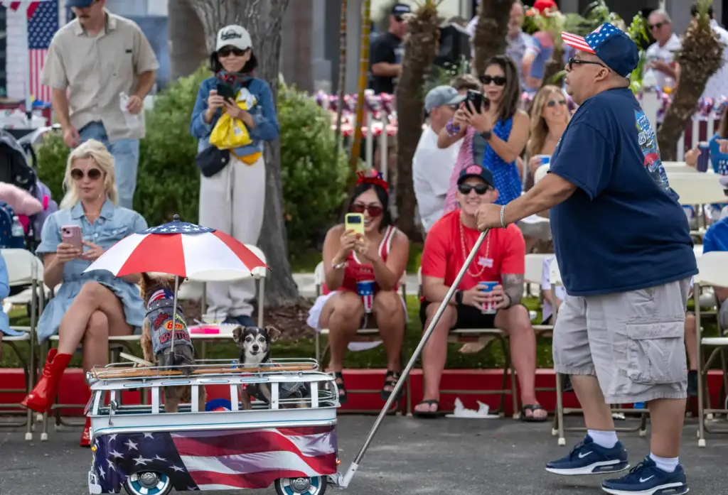 Sergio Prado of Temecula pushes his dogs, Homer and Dexter,...