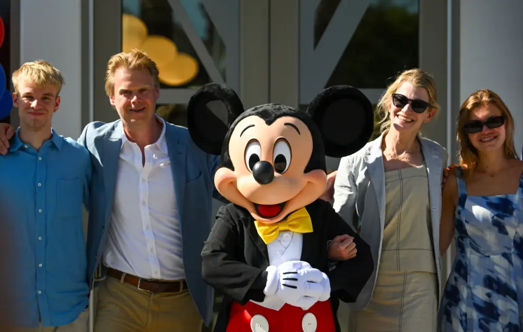 Luke Montagu, 12th Earl of Sandwich, stands with Mickey Mouse,...