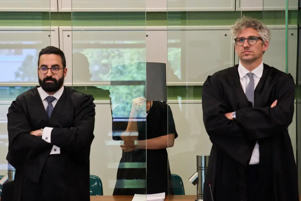 The defendant covering his face in court during a trial