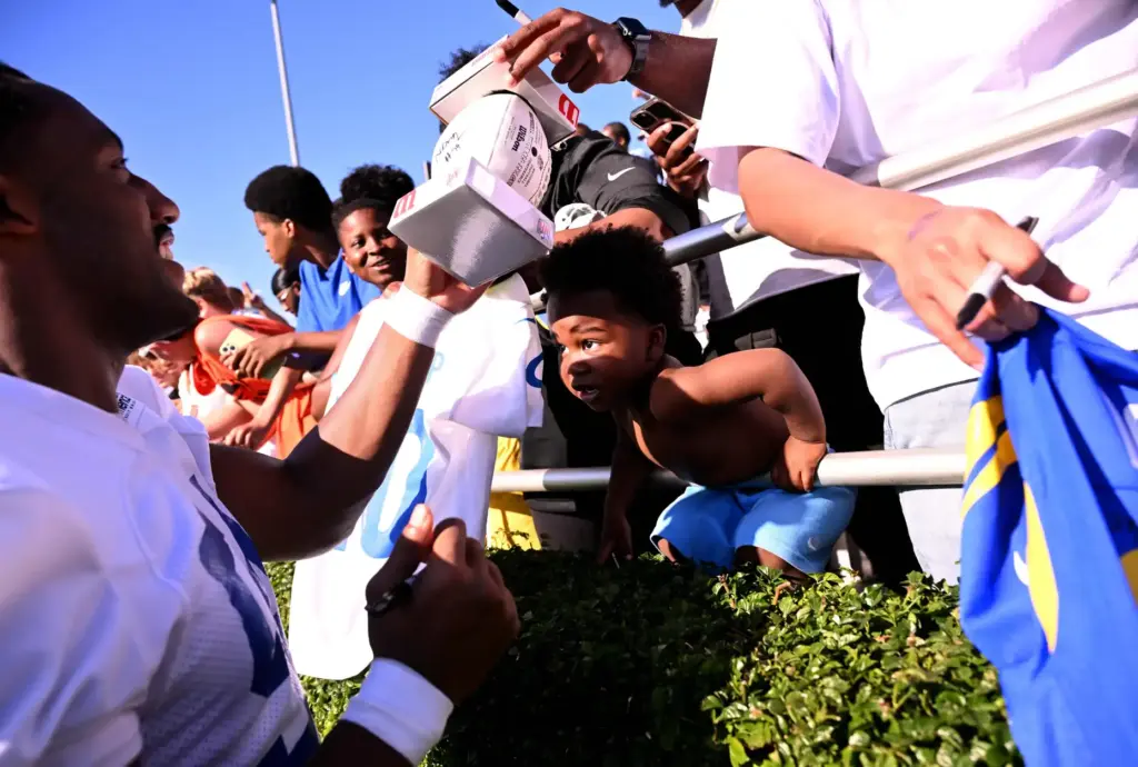 Rams inside linebacker Nikhal Hill-Green signs autographs during the first...
