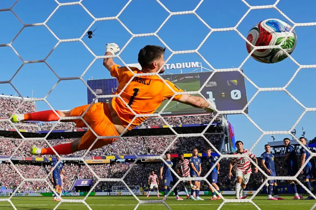 Malik Tillman scores from a free kick against Bosnia.