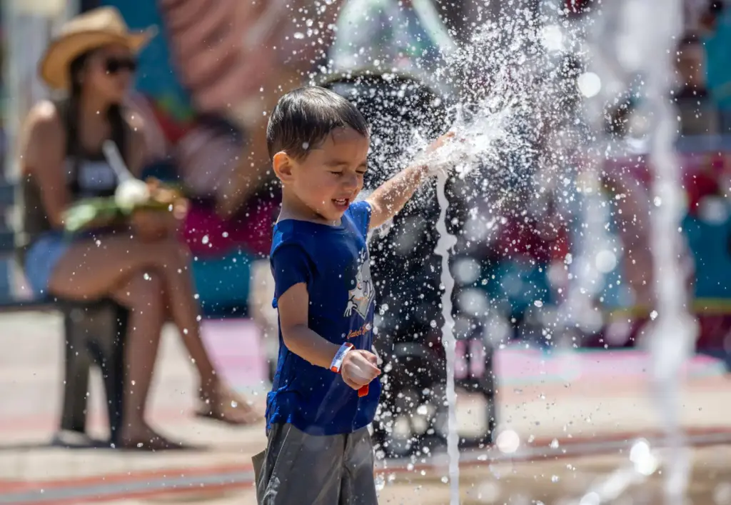 Ezekiel Lich, 4, of Fontana plays in a splash pad...