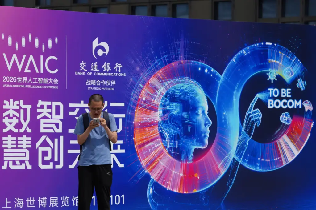 A visitor stands near a poster for the World AI...