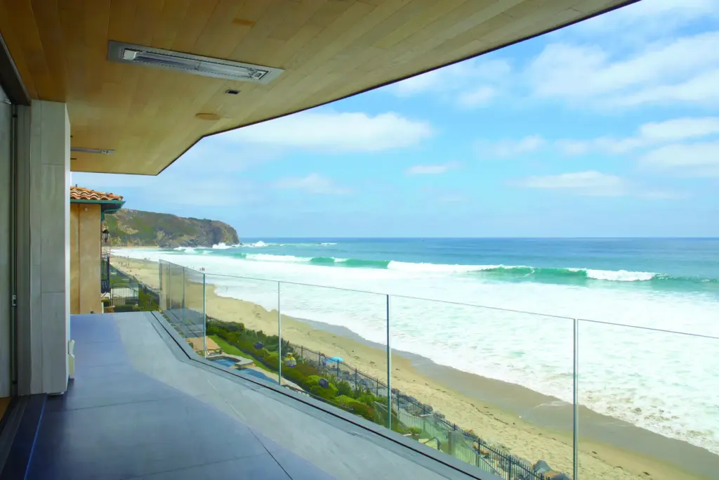 A glass-railed terrace outside of the primary suite offers sweeping...