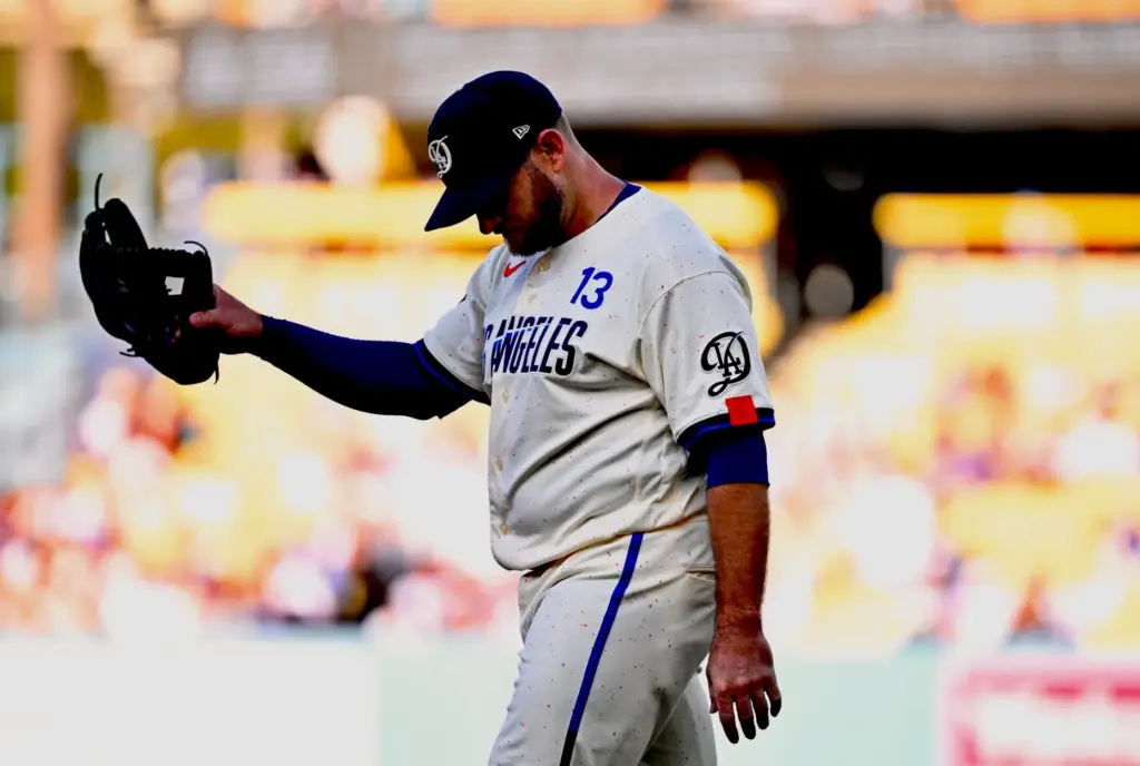 Third baseman Max Muncy of the Dodgers reacts after committing...