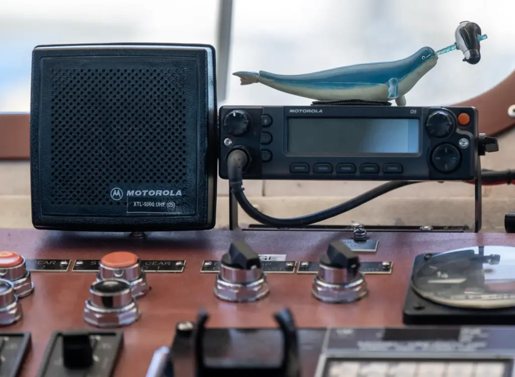 A narwhal toy sits atop a radio in the bridge...