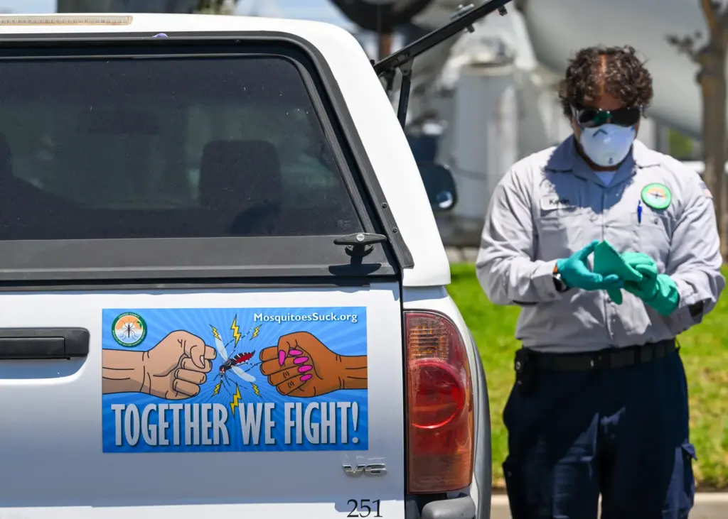 Vector Control Inspector Kevin Isunza prepares to look for mosquitoes...