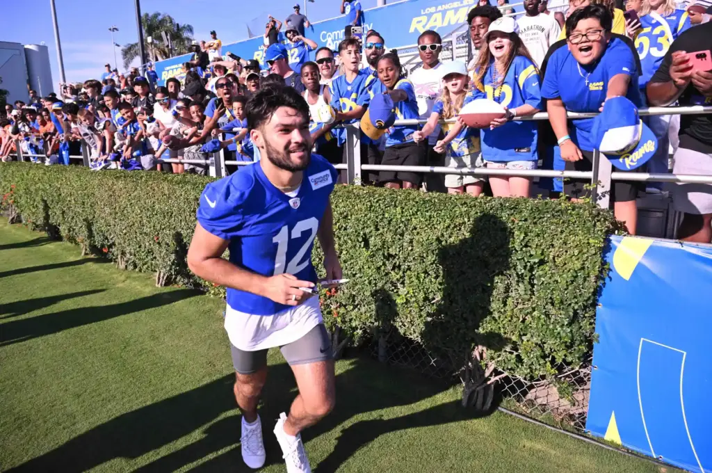 Rams wide receiver Puka Nacua signs autograhs the first day...