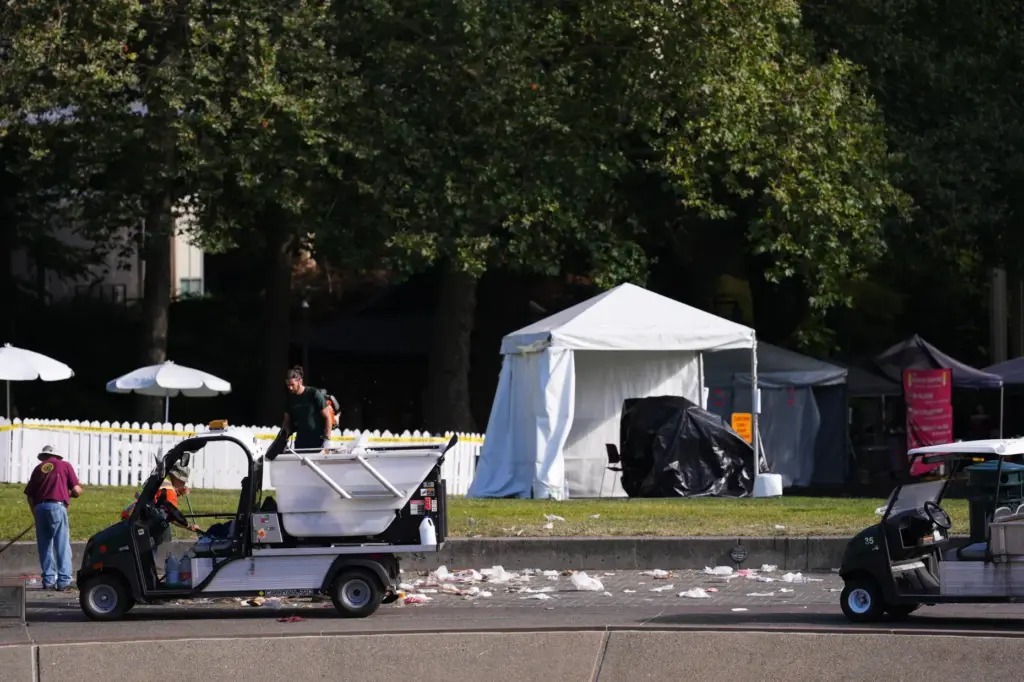 Workers clean up the day after a shooting at Seattle...