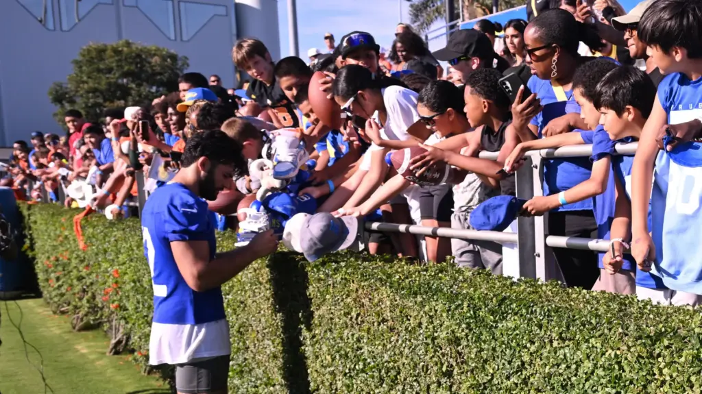 Rams wide receiver Puka Nacua signs autograhs the first day...