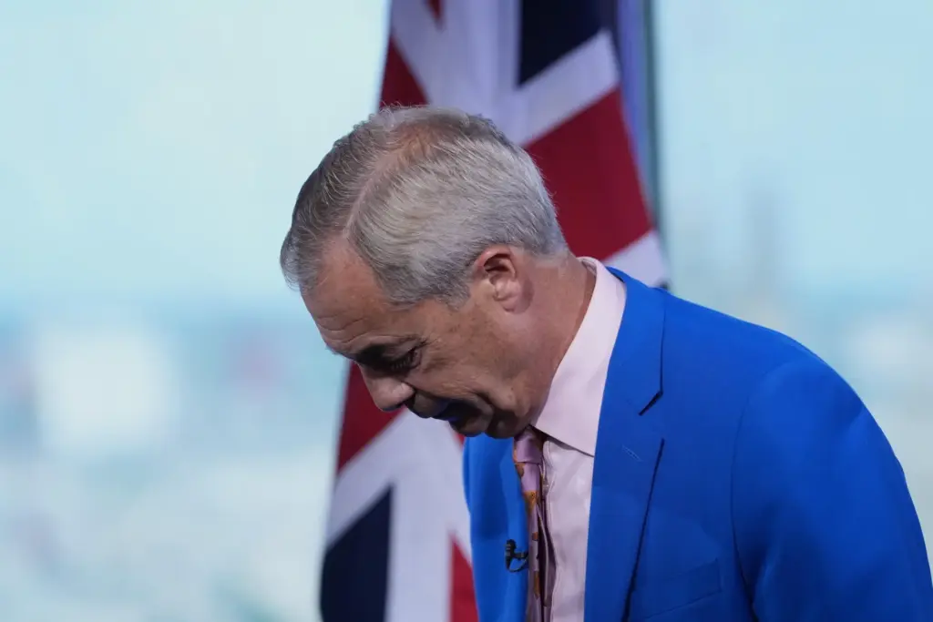 Reform UK leader Nigel Farage gestures as he makes a statement to the media.