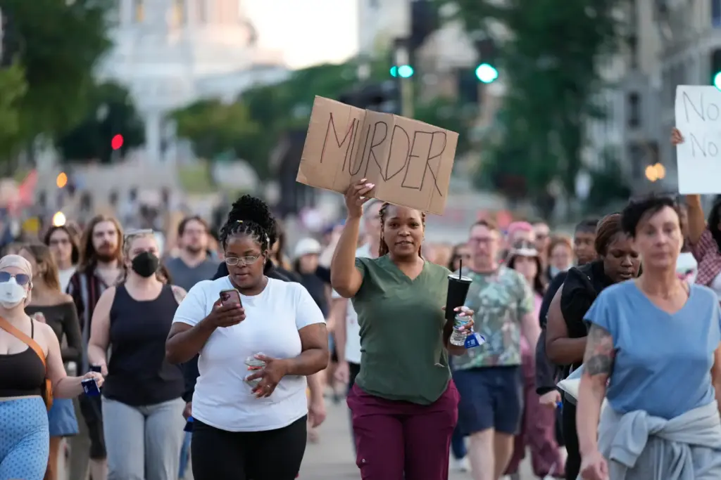 Protesters march after a Madison police officer shot and killed...