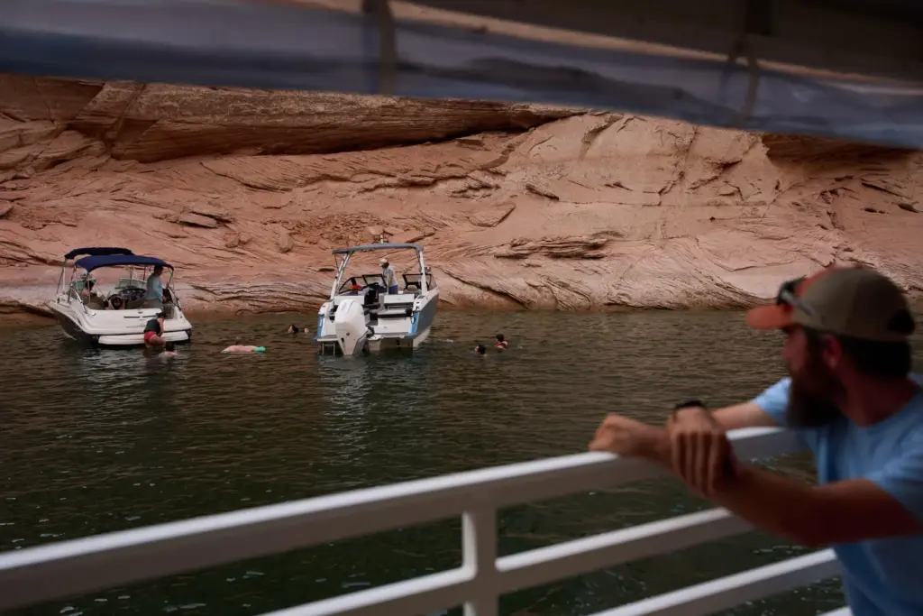 Boaters swim in a canyon on Lake Powell at the...