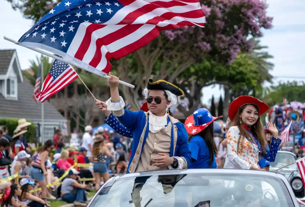 California State Assemblyman Tri Ta waves an American flag as...