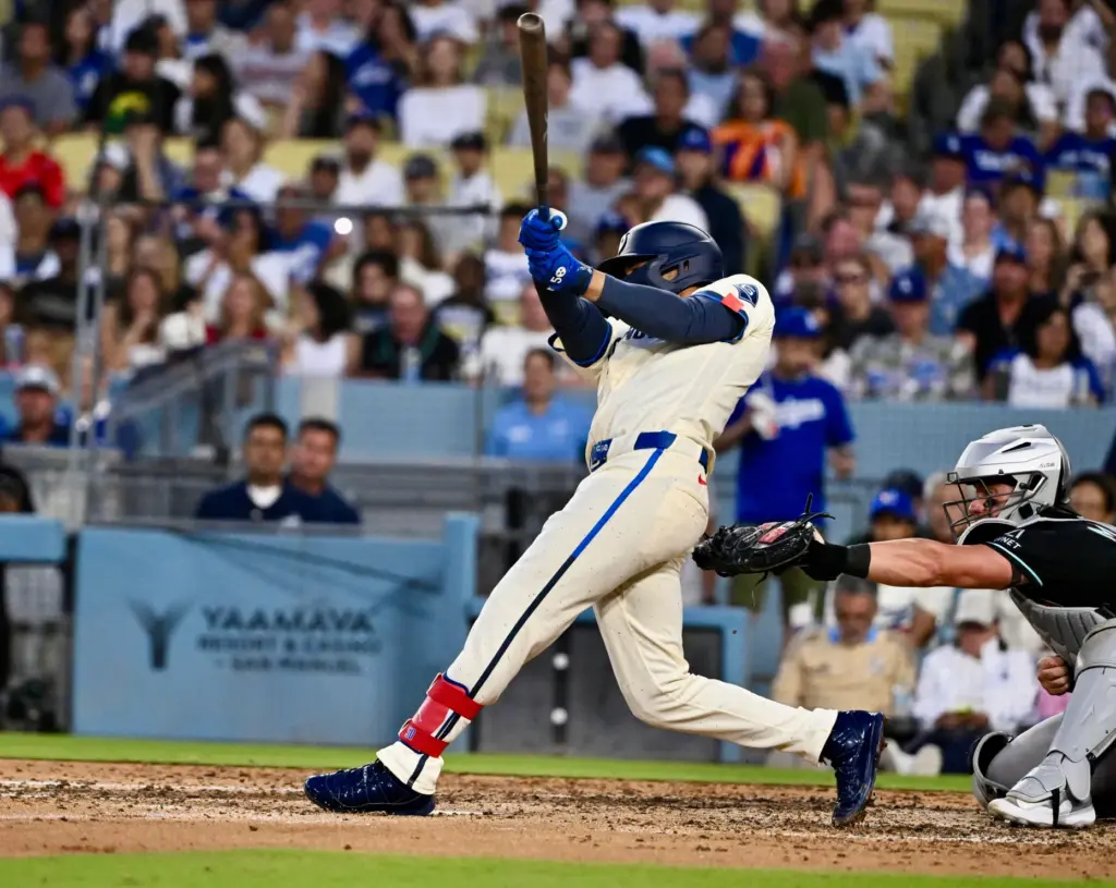 Mookie Betts of the Dodgers hits an RBI single as...