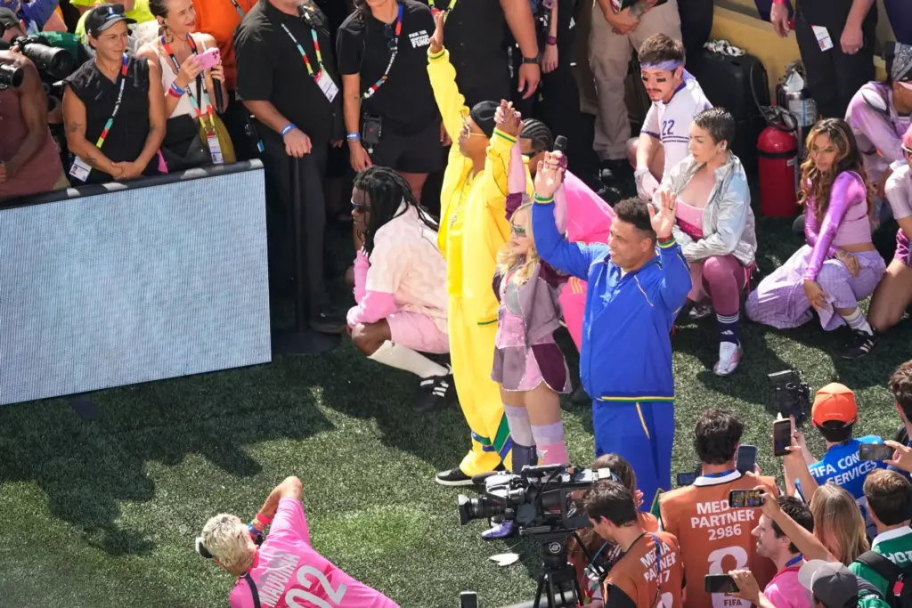 Madonna, stands with Ronaldinho and Ronaldo, in blue, as she...