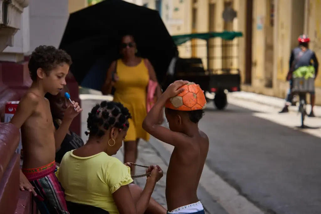 People spend time outside during a blackout in Havana, Cuba,...