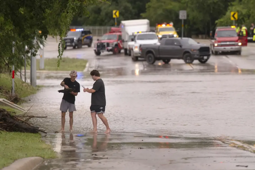 Reece Noble and Gavyn Steffek photograph a tortoise they found in flood waters.
