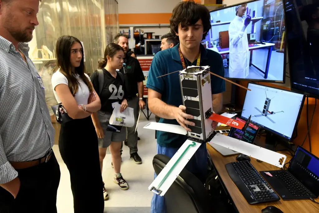 Brian Burke shows off the student-developed Maveric satellite at USC’s...