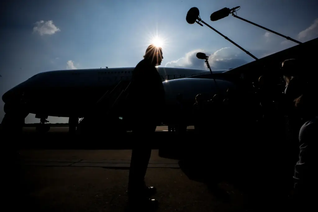 President Donald Trump speaks with reporters before boarding the new...